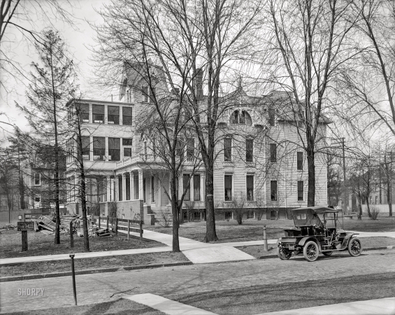 Photo showing: The Big House. -- Detroit circa 1908. Automobile parked in front of three-story house with side porch.