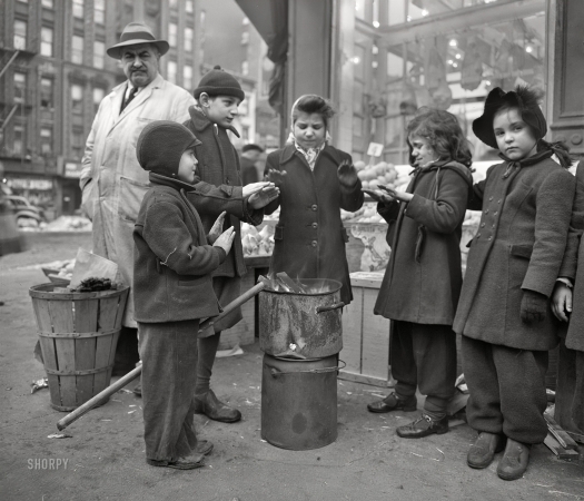 Photo showing: Small Fry - -- February 1943. New York. Italian-American children warming their hands
by fruit stand outside a grocery store at First Avenue and Tenth Street.