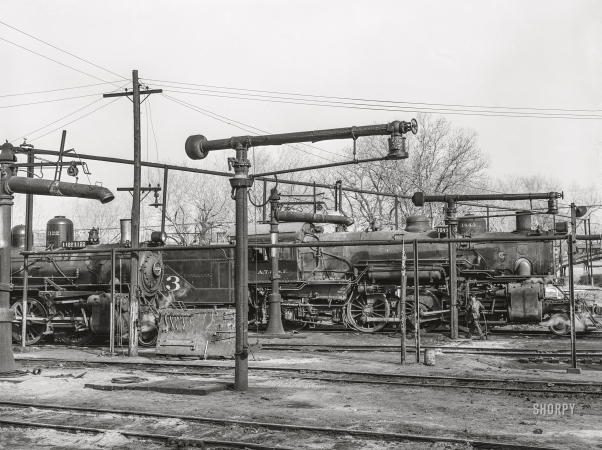 Photo showing: Hydration Station II -- March 1943. Waynoka, Oklahoma. Oil and water derricks near the Atchison, Topeka & Santa Fe Railroad roundhouse.