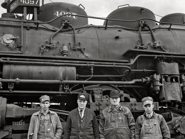 Photo showing: Santa Fe Four -- March 1943. Wellington, Kansas. Santa Fe Railroad crew in front of their engine.