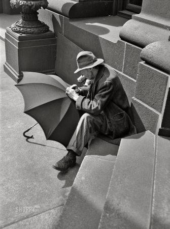 Photo showing: Harry Poppins -- March 1943. Baltimore, Maryland. Man repairing an umbrella.