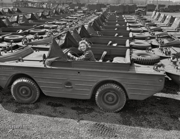 Photo showing: Miss Amphibious -- April 1943. Detroit. Transportation of U.S. Army equipment. Amphibian jeeps waiting to be loaded on trucks.