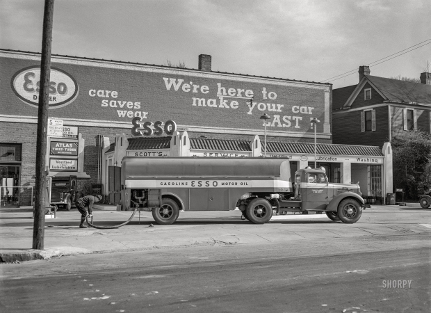 Photo showing: Verified Lubrication -- March 1943. Charlotte, North Carolina. Gasoline truck making a delivery at a filling station.